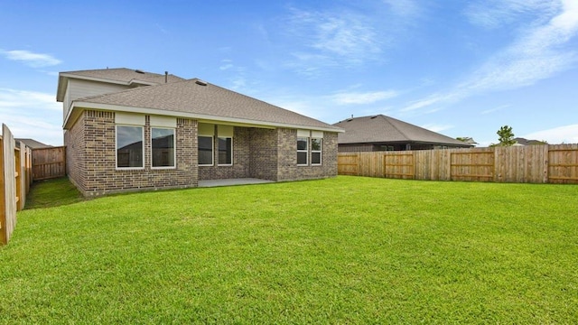 rear view of house featuring a lawn