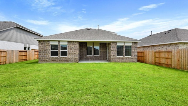 rear view of property with a lawn and a patio area