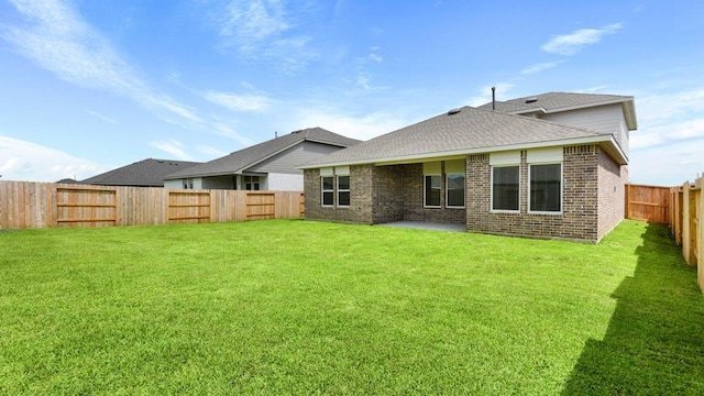 rear view of house with a lawn