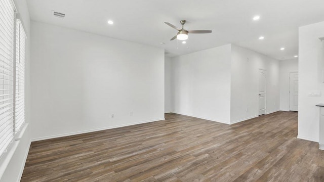 spare room featuring dark hardwood / wood-style floors and ceiling fan