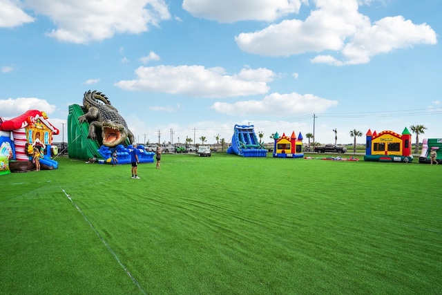 view of jungle gym featuring a lawn