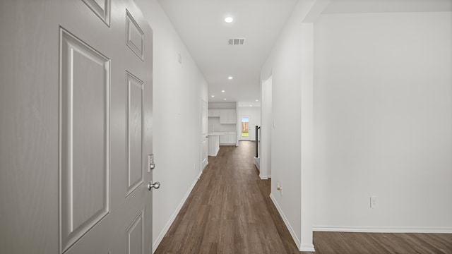 hall with dark hardwood / wood-style flooring