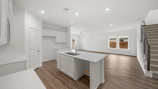 kitchen featuring a center island with sink, white cabinets, sink, ceiling fan, and dark hardwood / wood-style flooring