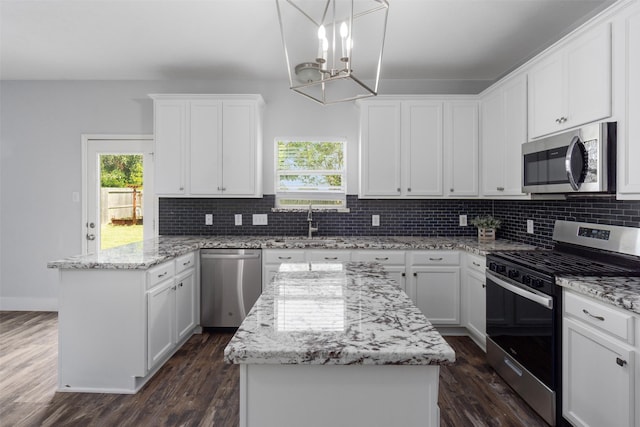 kitchen with dark hardwood / wood-style floors, a kitchen island, and stainless steel appliances