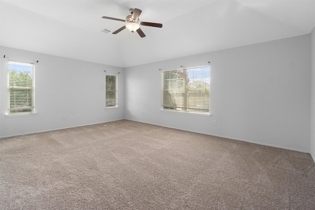 unfurnished room featuring carpet flooring, plenty of natural light, ceiling fan, and lofted ceiling