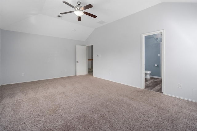 interior space with carpet flooring, ensuite bath, ceiling fan, and lofted ceiling