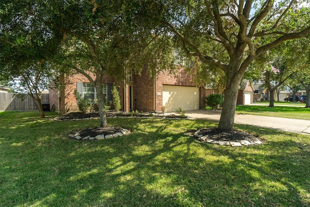 obstructed view of property with a garage and a front lawn