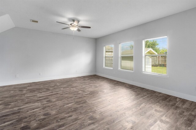 spare room with ceiling fan, dark hardwood / wood-style flooring, and vaulted ceiling