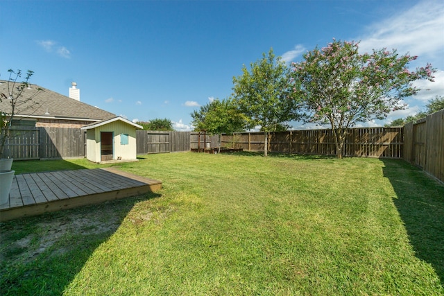 view of yard featuring a shed and a deck