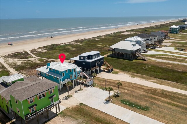 drone / aerial view with a water view and a beach view