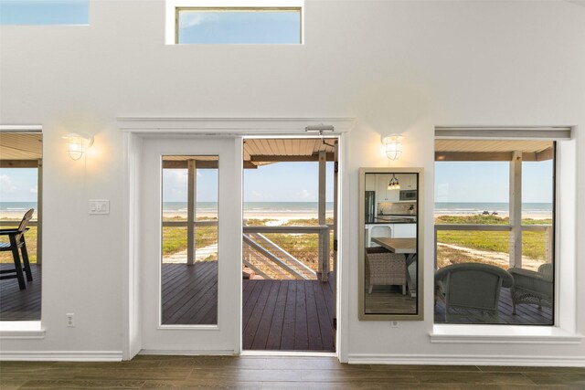 doorway to outside with a water view and dark hardwood / wood-style flooring