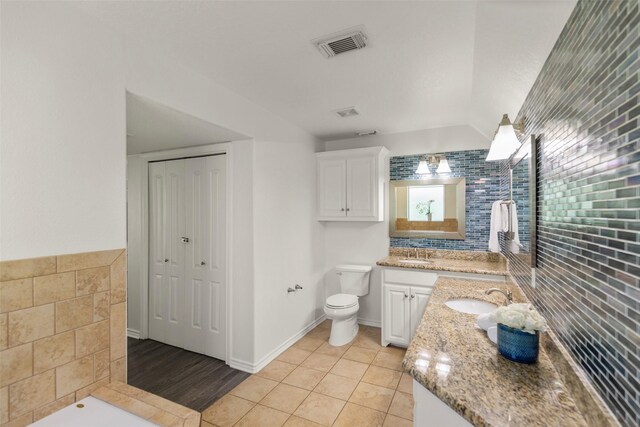 bathroom featuring vanity, toilet, and tile patterned floors