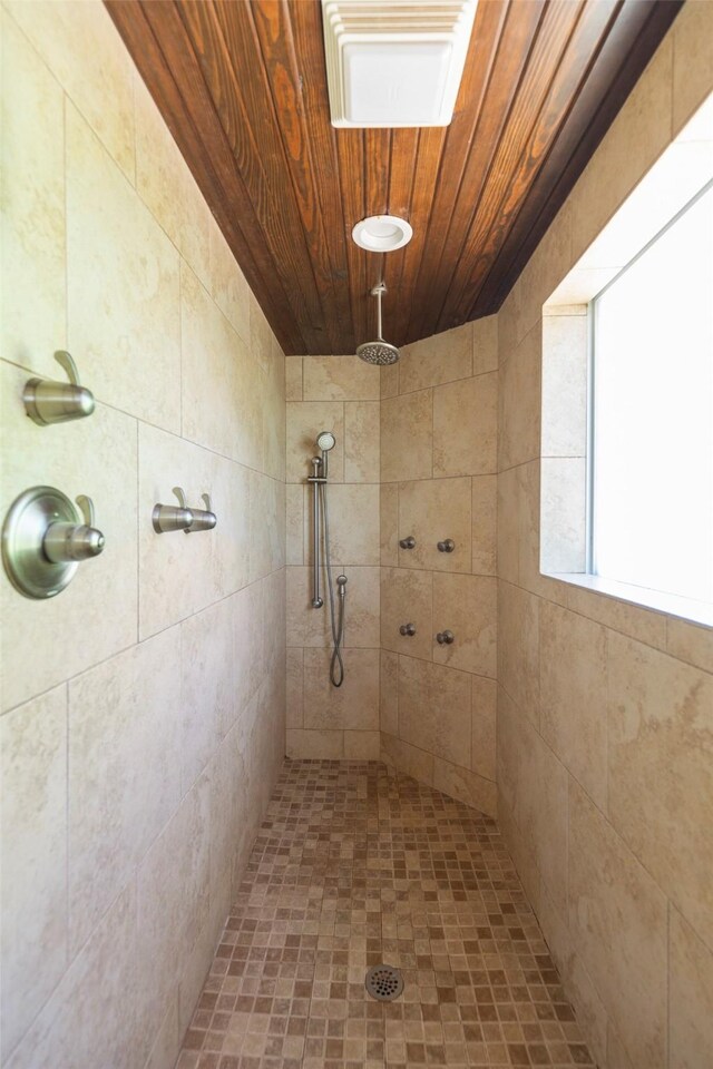 bathroom featuring tiled shower and wooden ceiling