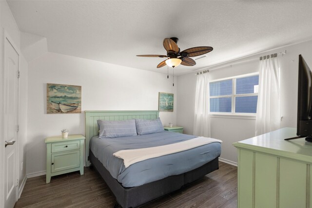 bedroom with ceiling fan and dark hardwood / wood-style flooring