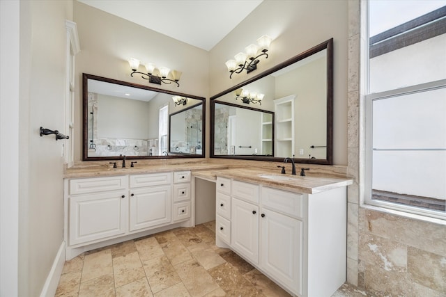 bathroom with vanity and a notable chandelier