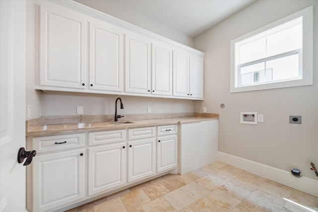 clothes washing area featuring sink, cabinets, hookup for an electric dryer, hookup for a gas dryer, and hookup for a washing machine