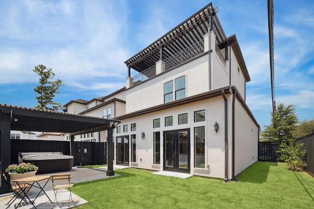 back of house with a lawn, french doors, a pergola, a patio area, and a hot tub