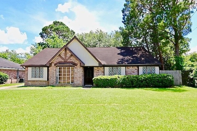 tudor-style house with a front lawn