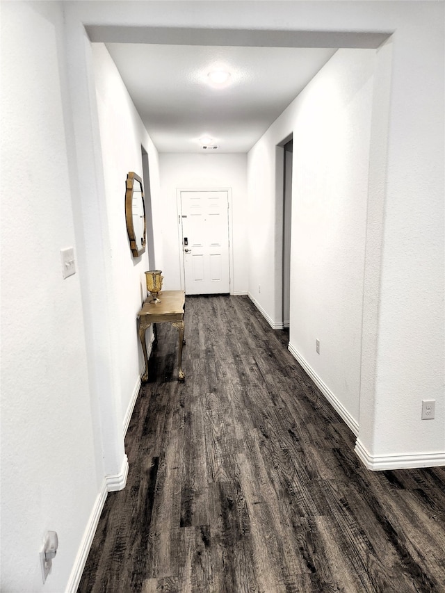 corridor with hardwood / wood-style floors