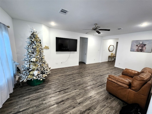 living room with dark hardwood / wood-style flooring and ceiling fan