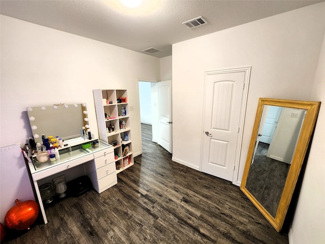 home office featuring wood-type flooring and a textured ceiling