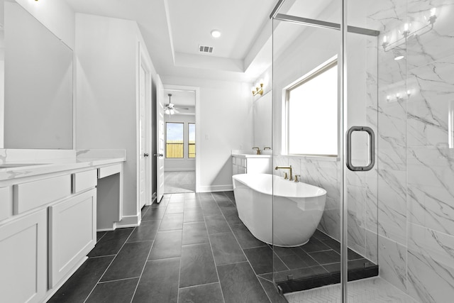 bathroom featuring vanity, ceiling fan, tile patterned flooring, and plus walk in shower