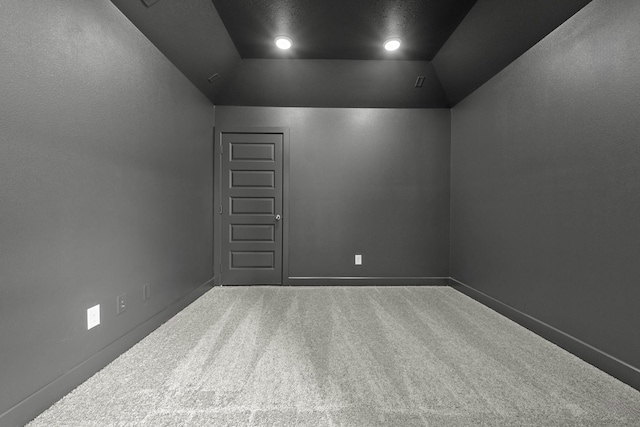 empty room with carpet and lofted ceiling