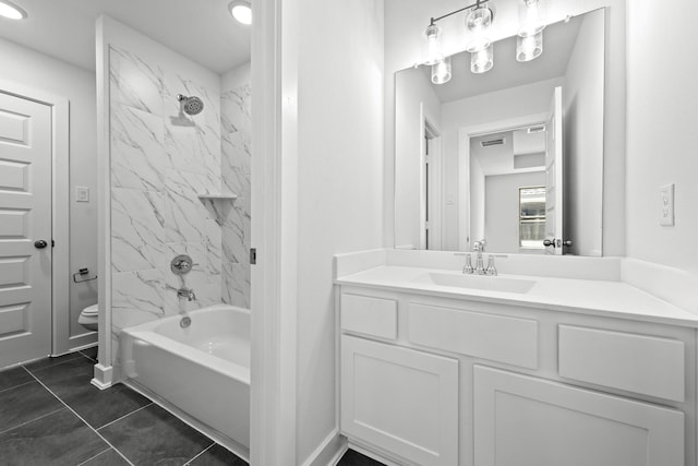 full bathroom featuring tile patterned flooring, vanity, tiled shower / bath combo, and toilet