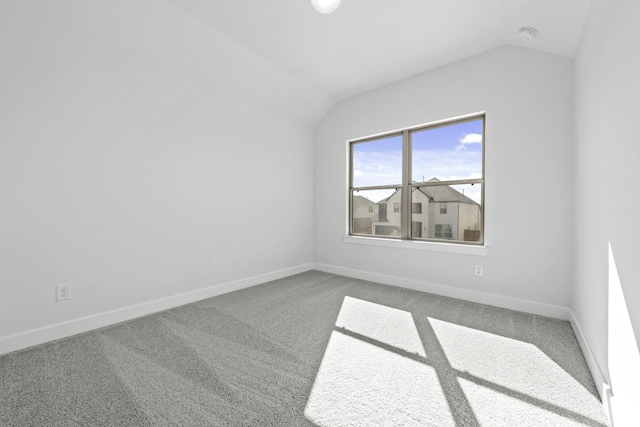 spare room with carpet and lofted ceiling