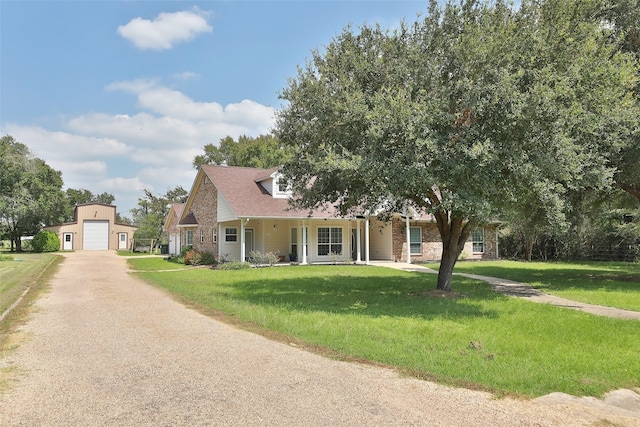 view of front facade with a front lawn, a garage, and an outdoor structure