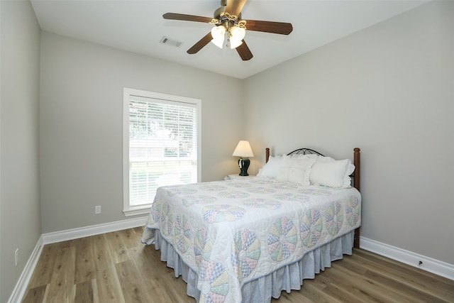 bedroom featuring ceiling fan and hardwood / wood-style flooring