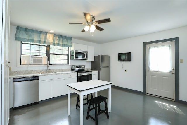 kitchen featuring ceiling fan, white cabinets, cooling unit, stainless steel appliances, and sink