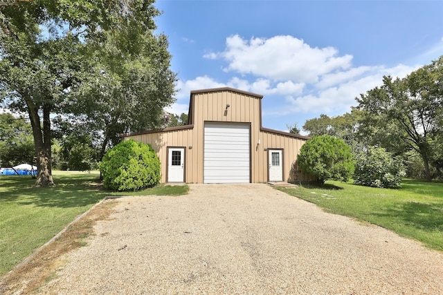 view of outbuilding featuring a yard and a garage