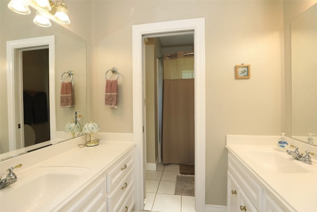 bathroom featuring a notable chandelier, tile patterned floors, and vanity