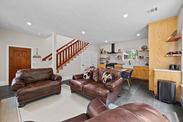 living area featuring recessed lighting, visible vents, stairway, and baseboards