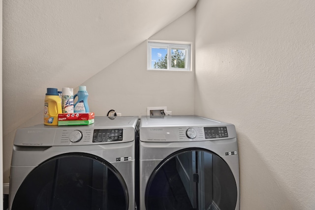 clothes washing area with washer and clothes dryer