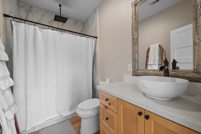 bathroom featuring hardwood / wood-style flooring, vanity, and toilet