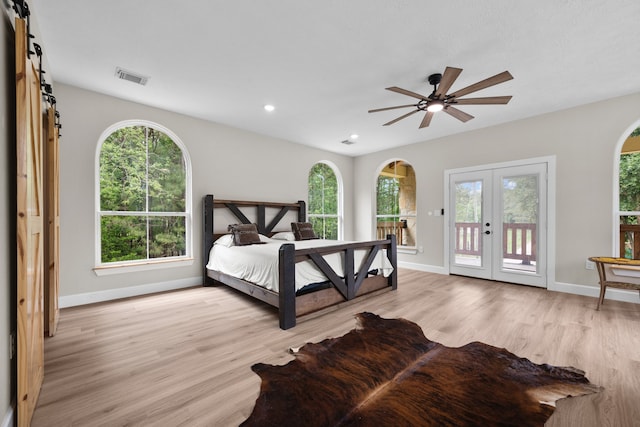 bedroom with ceiling fan, access to exterior, french doors, and light hardwood / wood-style floors