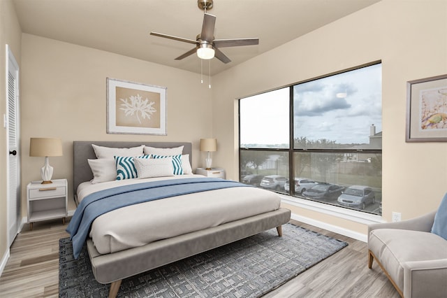 bedroom featuring ceiling fan and light hardwood / wood-style flooring