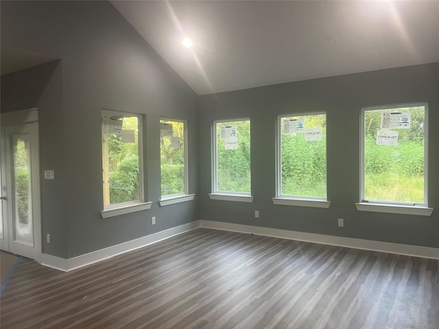 unfurnished sunroom featuring vaulted ceiling and a healthy amount of sunlight