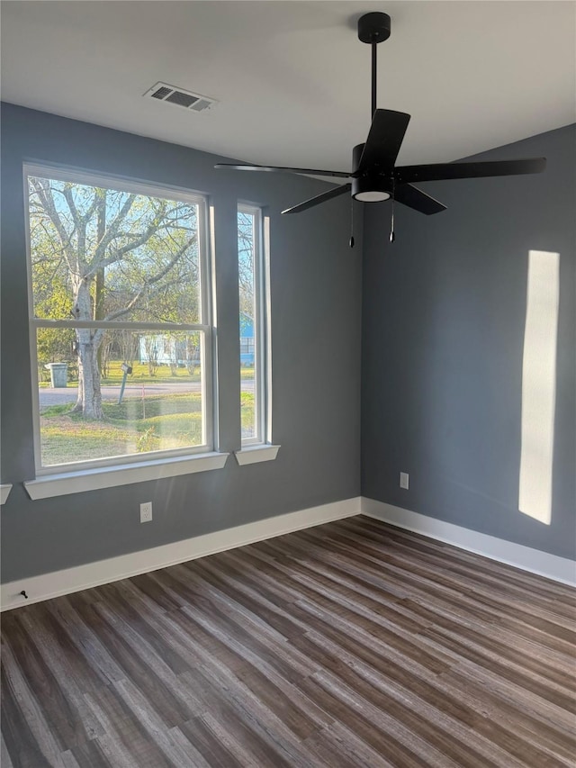 unfurnished room featuring dark wood-type flooring and ceiling fan