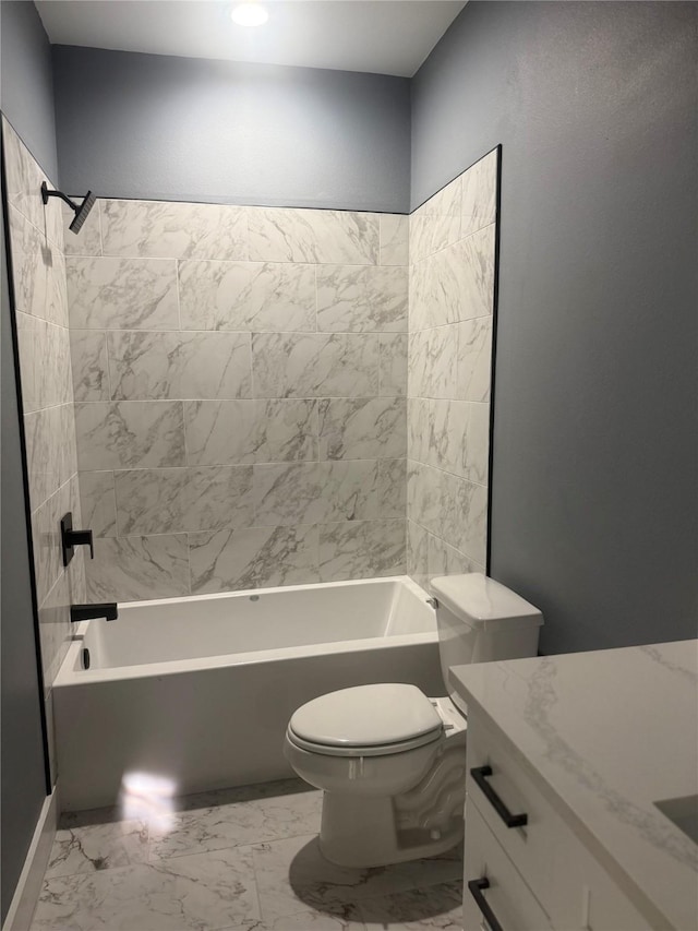 full bathroom featuring tiled shower / bath, vanity, and toilet