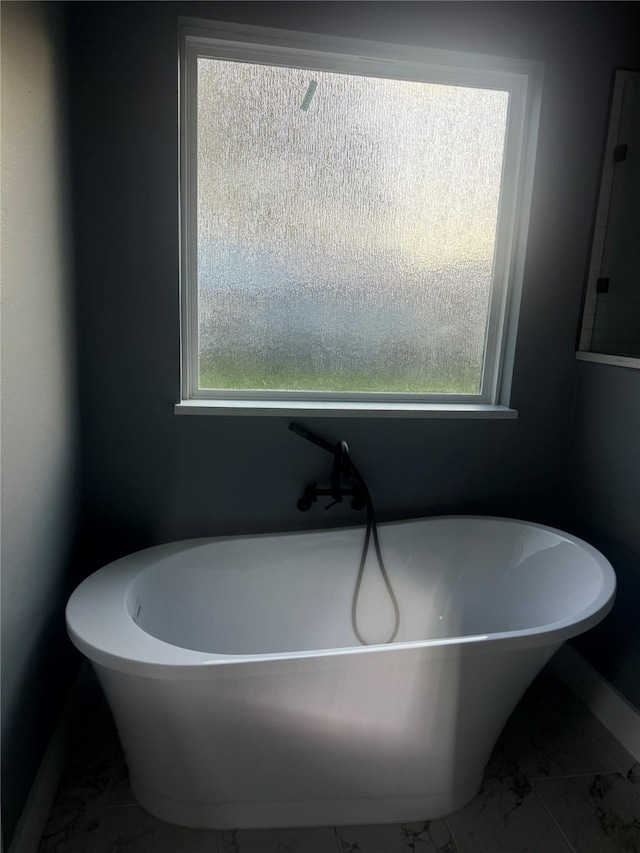 bathroom with a tub to relax in