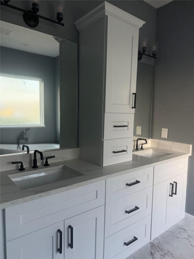 bathroom featuring vanity and a washtub