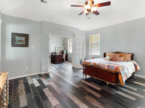 bedroom with ceiling fan and dark hardwood / wood-style flooring