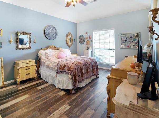 bedroom with ceiling fan and dark hardwood / wood-style floors