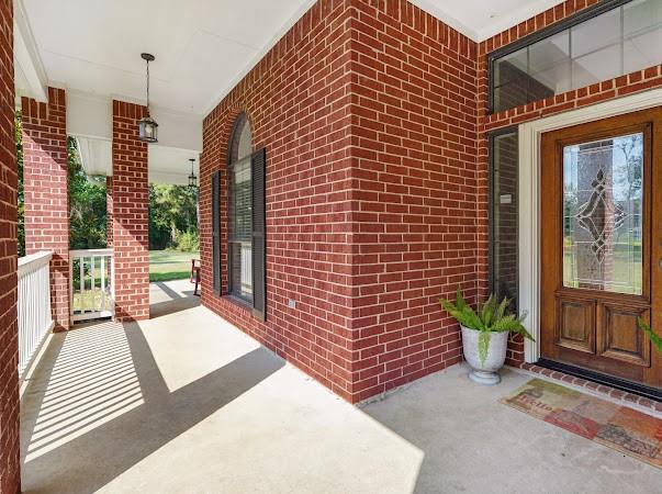 view of exterior entry with a porch