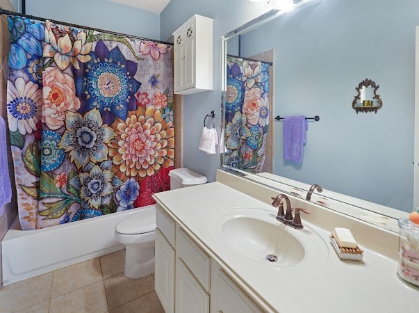 full bathroom with tile patterned floors, vanity, toilet, and shower / bath combo