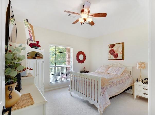 bedroom with access to exterior, light colored carpet, and ceiling fan