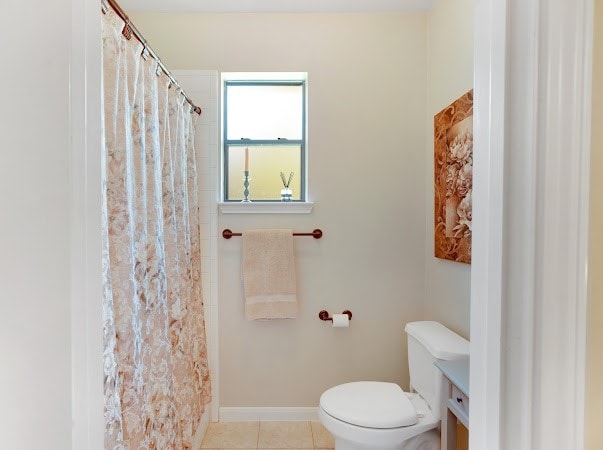 bathroom featuring toilet and tile patterned floors